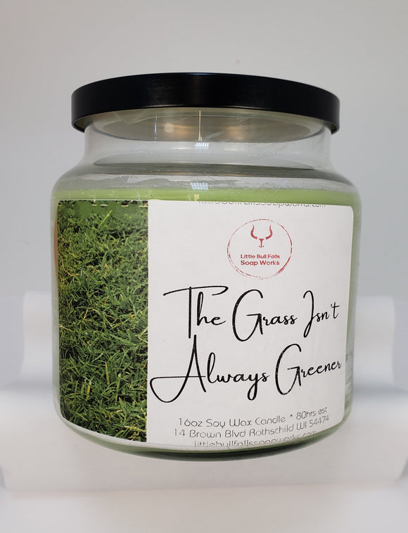 Fresh Cut Grass scnted soy wax candle with a wood wick. Made by Wisconsin soap & cnadle co Little Bull Falls Soap Works. An iconic, aromatic blend of freshly cut grass on a refreshing summer afternoon.    Top notes: Greens, Herbs  Middle notes: Sweet Grass, Sage  Base notes: Dirt, Earth, Stems