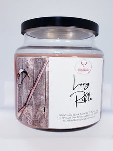 Long Rifle soy wax candle sports a wood wick. Long Rifle candle is outdoors on a winter day...Simply amazing if we may say so ourselves! This fragrance begins with top notes of bergamot, orange, and lemon; with middle notes of geranium, lily, and rose; and base notes of patchouli, vetiver, and tonka beans. This fragrance is one of the most well-rounded fragrances we have ever smelled.