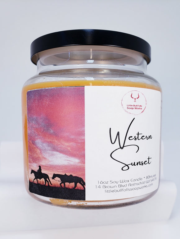 Western Sunset Soy wax wood wick candle made by Little Bull Falls Soap Works. Sparkling citrus and a hint of spice lead to the warm oriental signature of this scent.  Tobacco leaf and western cedar are blended with a rich base of sandalwood as soft moss finishes the blend